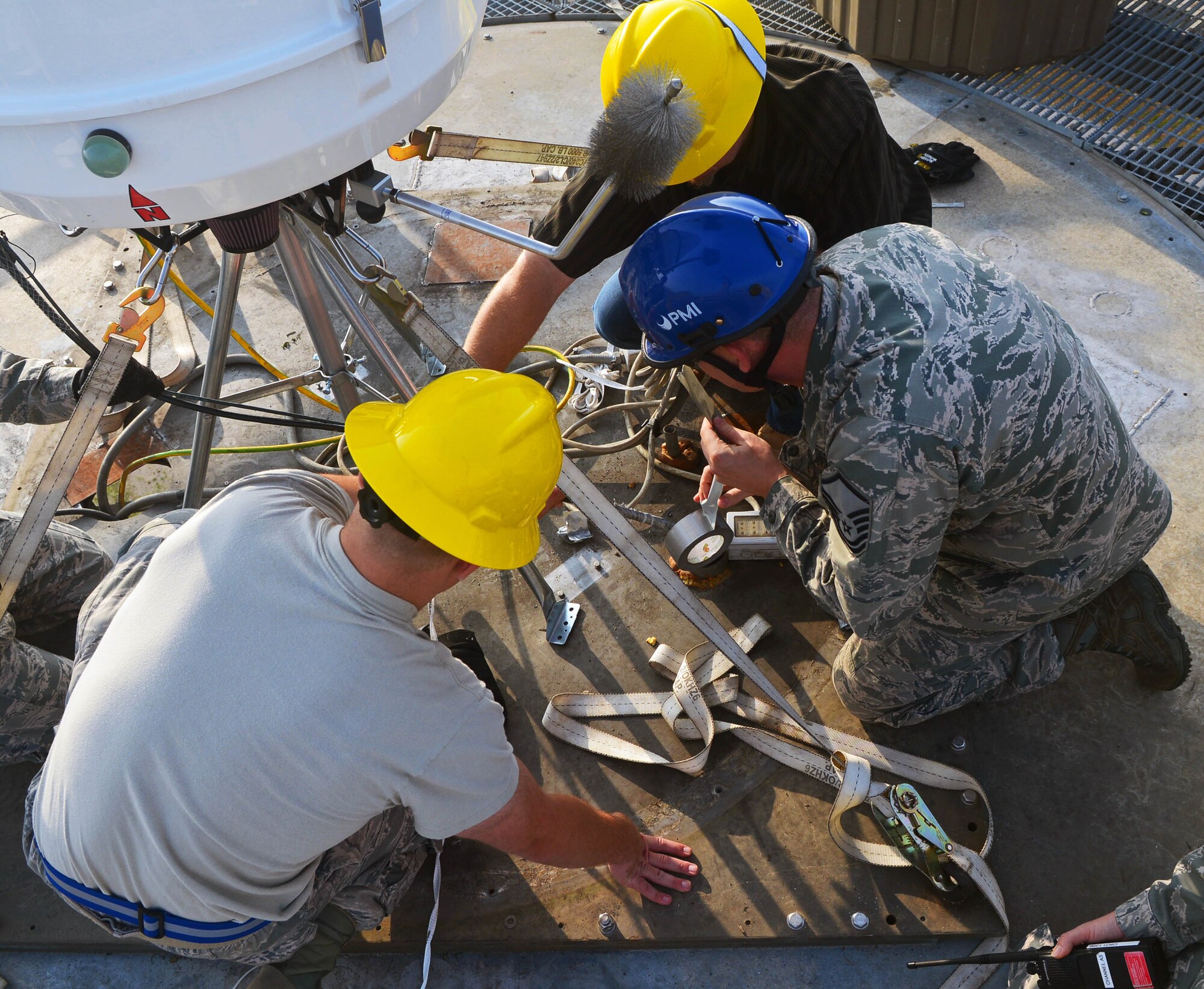 Members of the 1st Communications Maintenance Squadron fix and adjust wires for the new Portable Doppler Radar system at Aviano Air Base, Italy, Oct. 19. The new system offers networking capability that allows Aviano to communicate with other bases in Europe. (U.S. Air Force photo/Airman 1st Class Matthew Lotz)