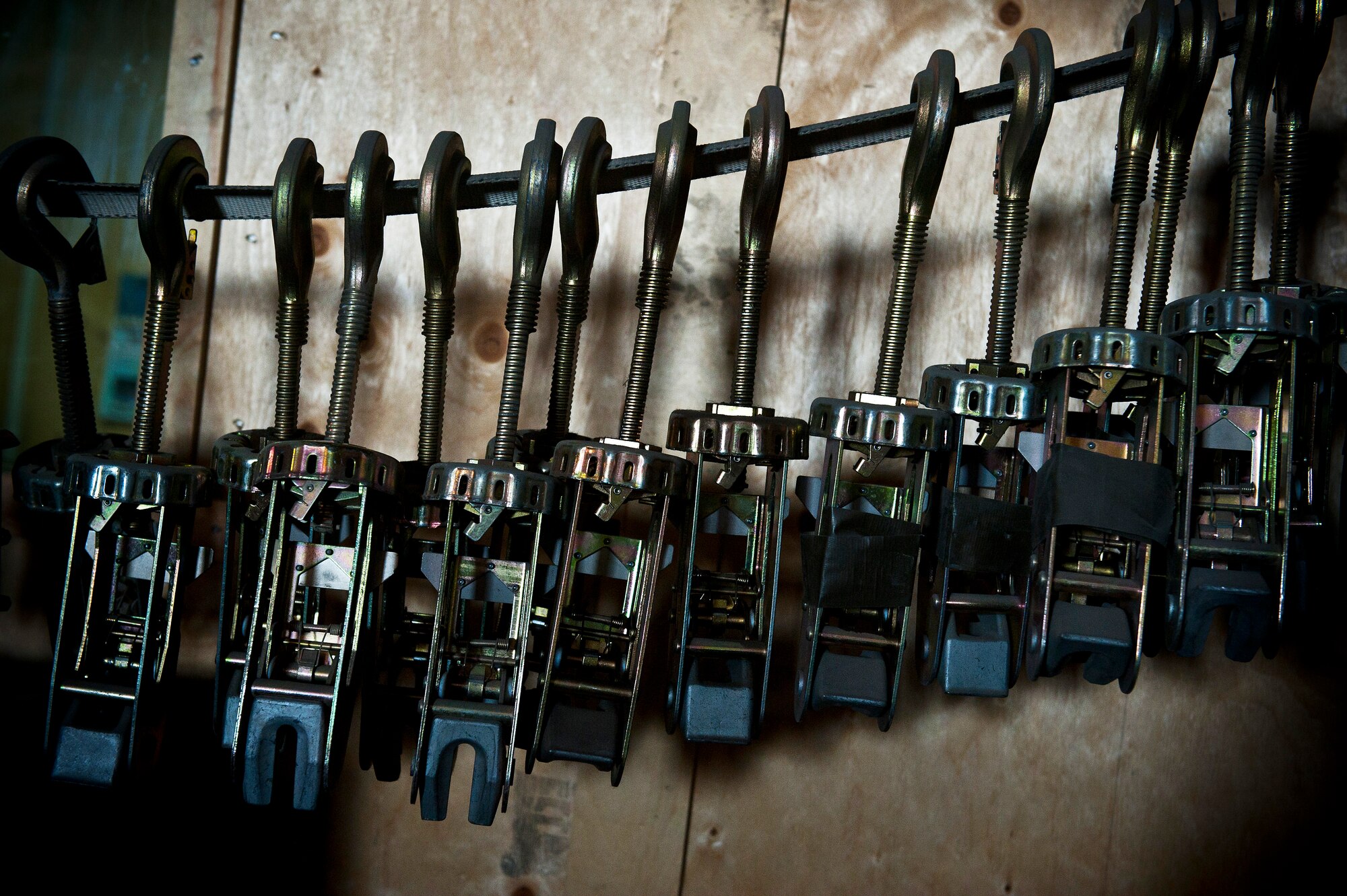 A line of cargo tie-downs hang inside the Travel Management Office at the Transit Center at Manas, Kyrgyzstan, Oct. 23, 2012. The cargo tie-downs are a primary tool for securing cargo on palettes. The Transit Center Travel Management Office Airmen and Kyrgyz Republic Ministry of Defense members strengthened partnership and cooperation during the transportation aviation exchange. (U.S. Air Force photo/Senior Airman Brett Clashman)