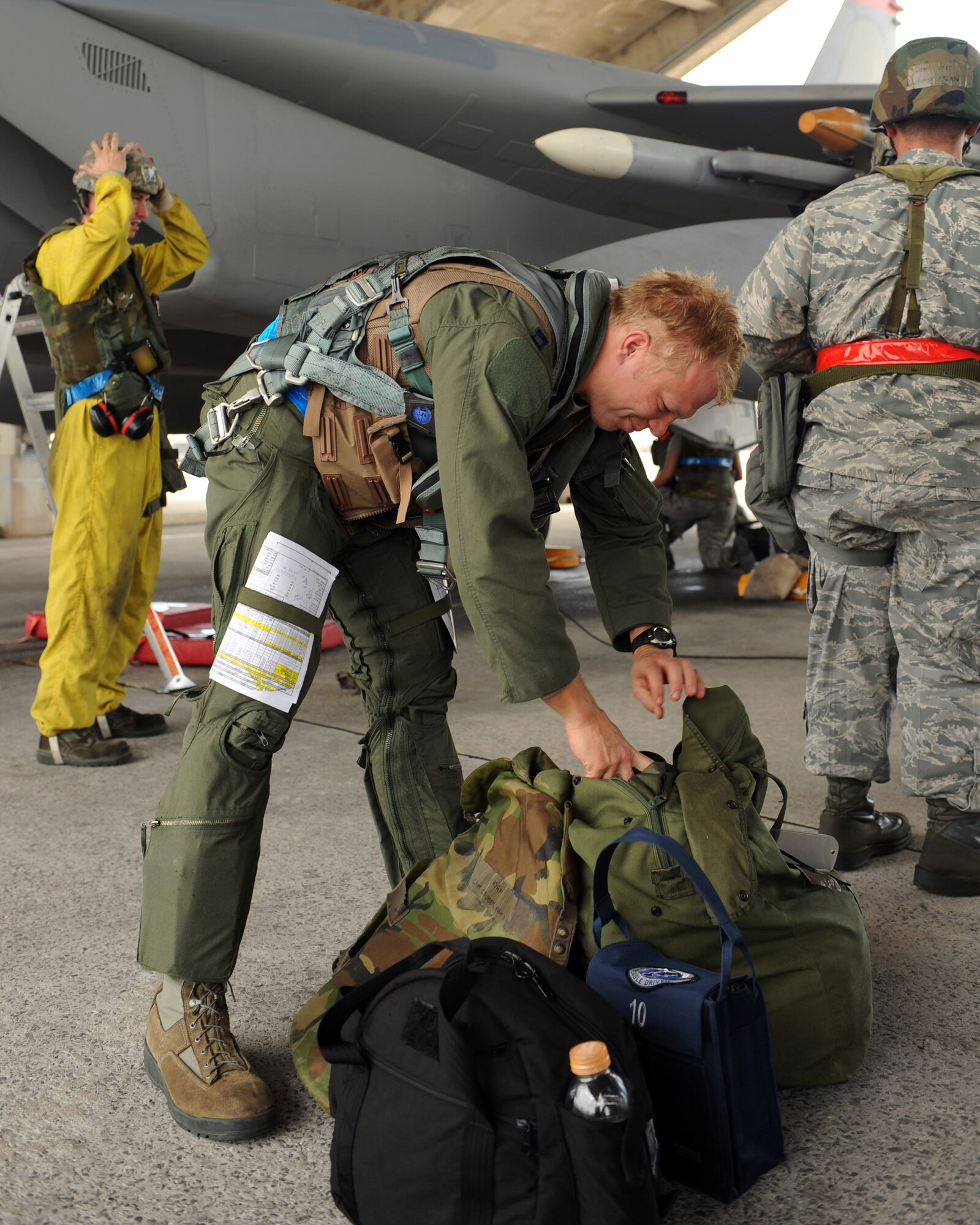 U.S. Air Force Capt. Hunter Grunden, 44th Fighter Squadron pilot, removes his field gear from his bag after returning from a flight in a U.S. Air Force F-15 Eagle during Exercise Beverly Bearcat 12-1, an operational readiness inspection on Kadena Air Base, Japan, Oct. 24, 2012. The Pacific Air Forces inspection team has been evaluating the 18th Wing’s capability to perform its mission during contingency operations. (U.S. Air Force photo/Airman 1st Class Hailey R. Davis)