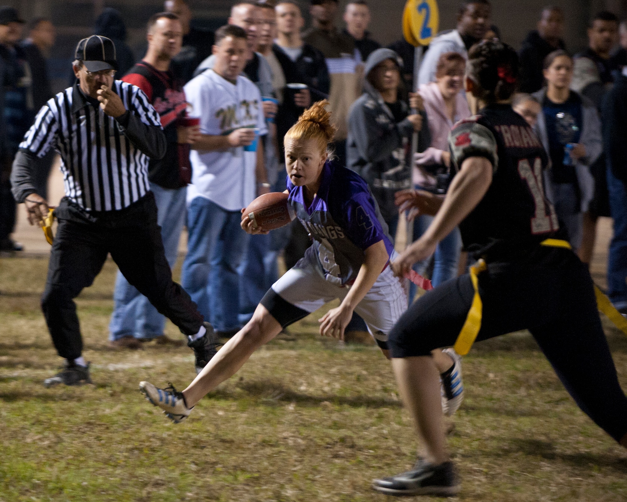 Sahtara Wehe, 8th Maintenance Squadron, Med Dawgs quarterback gets blitzed by the 8th Security Forces Lethal Ladies during the powder puff championship game at Kunsan Air Base, Republic of Korean, Oct 20, 2012. Wehe was able to bring the Med Dawgs into scoring position several times throughout the night and threw three touchdown passes. (U.S. Air Force photo/Senior Airman Marcus Morris)