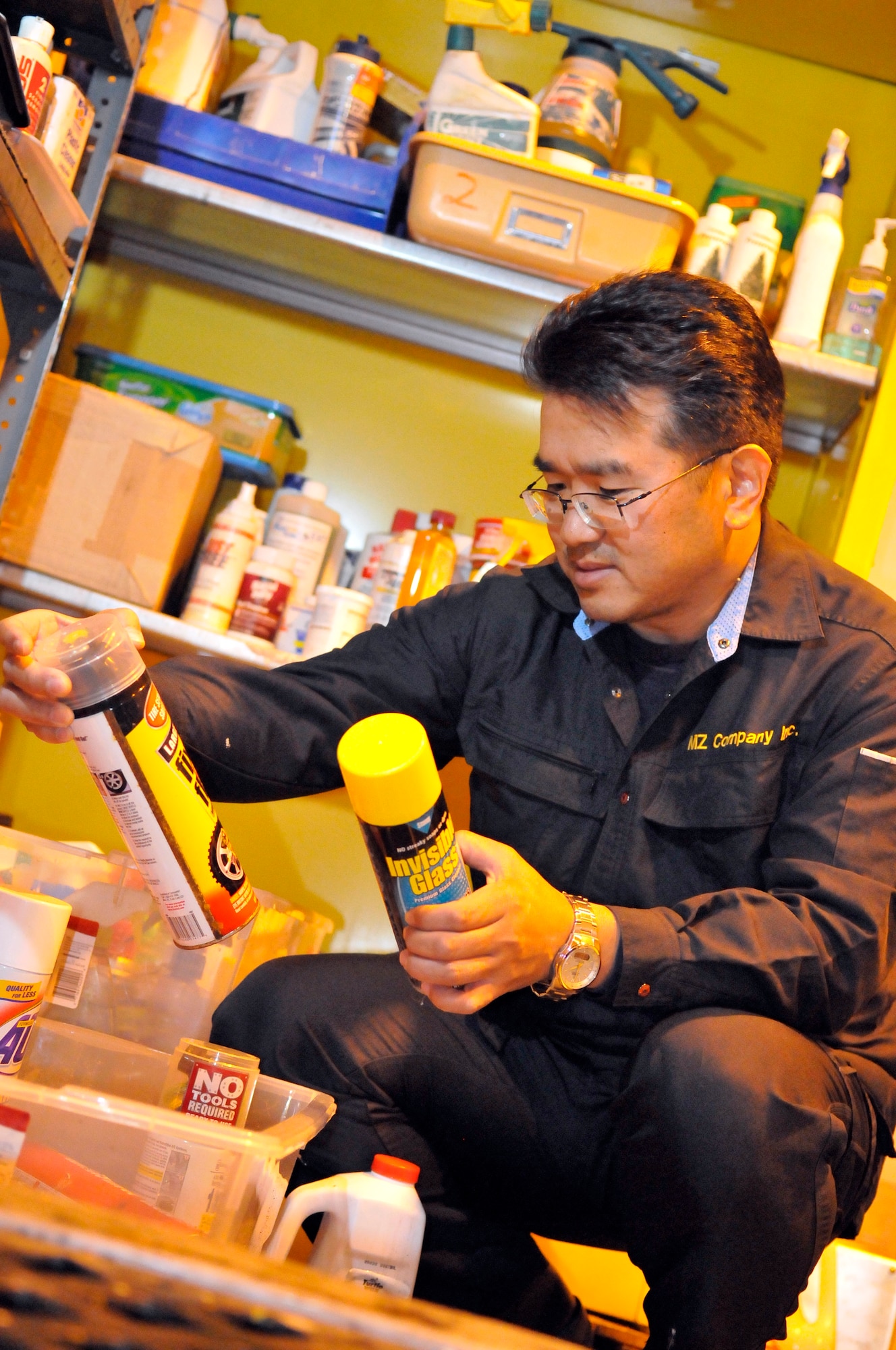 Koji Takayama, hazardous waste storage area site manager, sorts through items that will be placed in the free issue area at Misawa Air Base, Japan, Oct. 24, 2012. The free issue area is a place where status of force agreement members can drop off or pick up any unwanted household cleaners, car care products or bottled gases for free. (U.S. Air Force photo by Tech. Sgt. Phillip Butterfield)