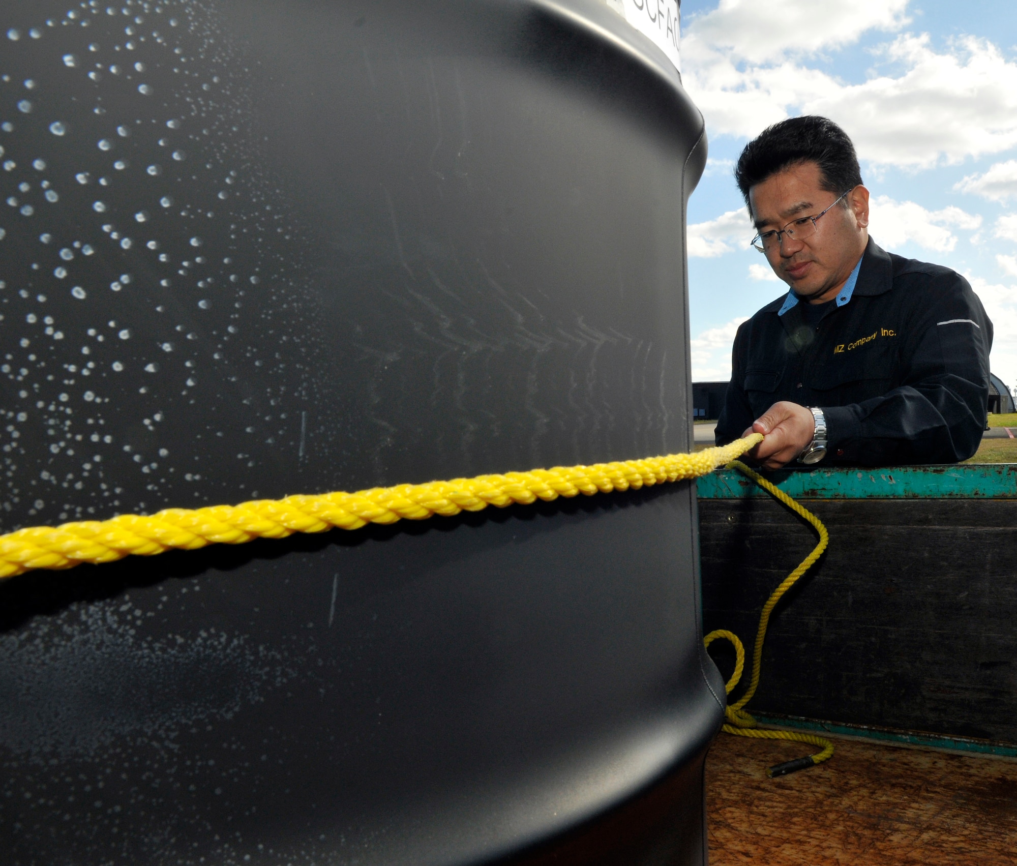 Koji Takayama, hazardous waste storage area site manager, secures a barrel of hazardous waste in the back of a truck at Misawa Air Base, Japan, Oct. 24, 2012. More than 77,000 tons of hazardous waste were collected and transferred off base in 2012. (U.S. Air Force photo by Tech. Sgt. Phillip Butterfield) 


