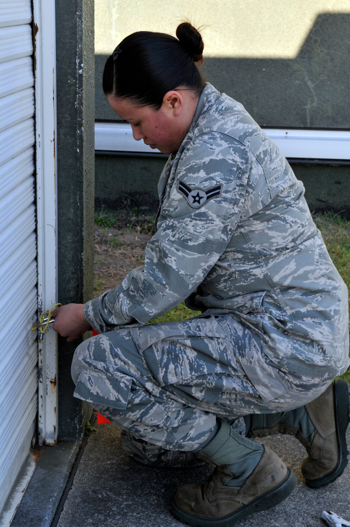 U.S. Air Force Airman 1st Class Gabrielle Carrillo, 13th Aircraft Maintenance Unit supply apprentice, unlocks a hazardous waste collection point at Misawa Air Base, Japan, Oct. 24, 2012.  The hazardous waste storage area collects waste from more than 40 collection points around base. (U.S. Air Force photo by Tech. Sgt. Phillip Butterfield) 


