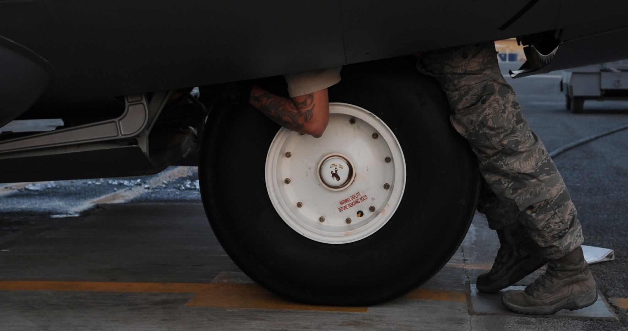 SOUTHWEST ASIA – Staff Sgt. T.J. Ogden, 386th Expeditionary Aircraft Maintenance Squadron crew chief, inspects the wheels of a C-130 Hercules after it lands here Oct. 23. Crew chiefs are responsible for the overall care of the aircraft. They marshal the aircraft into its spot, debrief the aircrew and run through a gamut of post operations inspections. They oversee the loading of fuel and liquid oxygen and check systems. (U.S. Air Force photo/Staff Sgt. Alexandra M. Boutte)