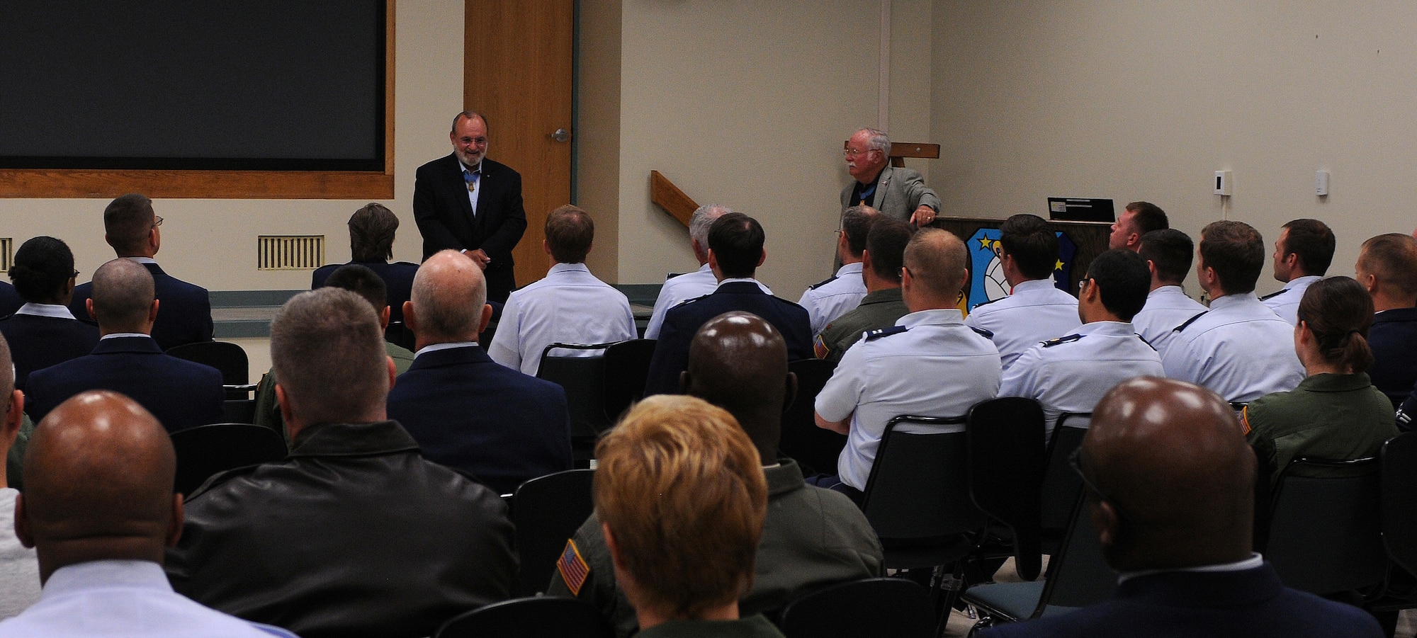 Two Medal of Honor recipients, Marine Col. Harvey C. Barnum Jr. (right), and Army 1st Lt. Brian M. Thacker, answer questions from the audience of approximately 50 reservists Oct. 14, 2012, on Dover Air Force Base, Del. One of the audience members asked the men to give their perspectives about how the military has changed over the past 25 years and how it has progressed. (U.S. Air Force photo/Senior Airman Erika Brooke)
