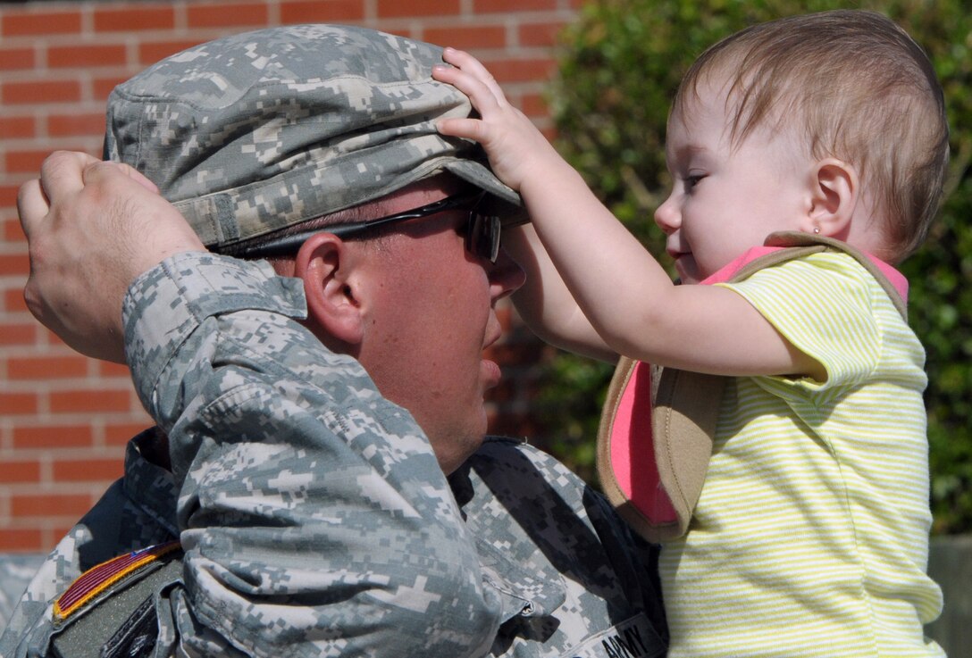 Army Spc. John Rose shares a moment with his daughter, MaKenzie, before he and fellow members of the 320th Military Police Company, 290th Military Police Brigade, leave Max R. Stover Army Reserve Center in St. Petersburg, Fla., to head for Fort Bliss, Texas, Oct. 22, 2012. The soldiers will train at Fort Bliss before deploying to Afghanistan.