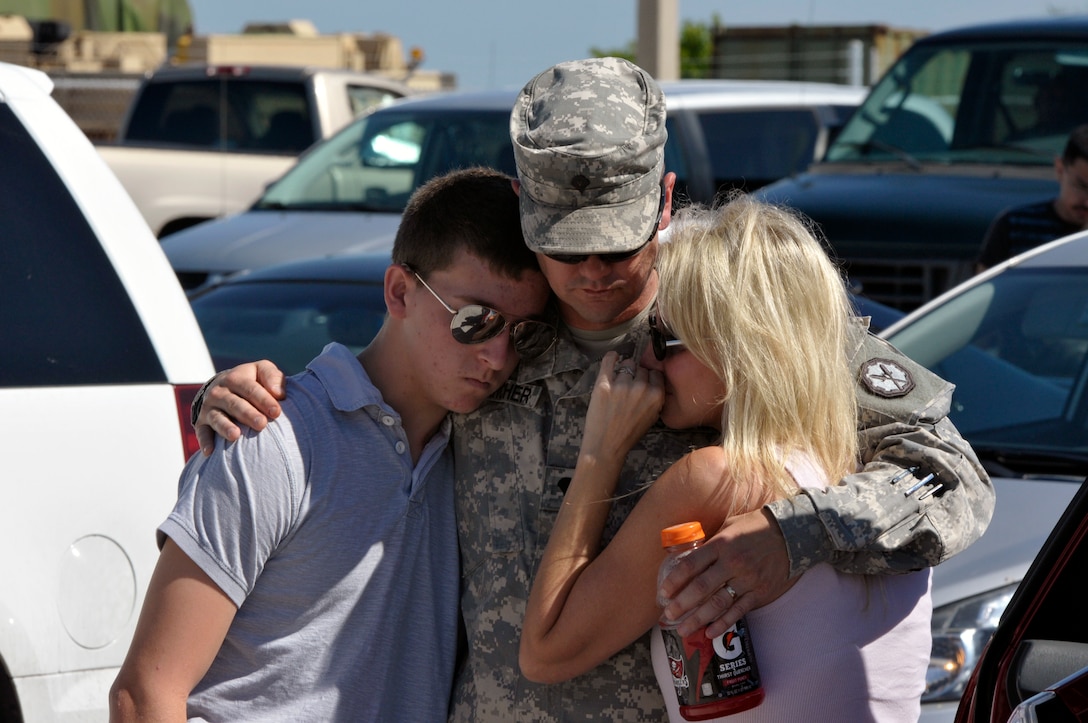 Army Spc. Donald Starcher hugs his wife, Stephanie, and son, Rick, before a final farewell formation at Max R. Stover Army Reserve Center in St. Petersburg, Fla., Oct. 22, 2012.