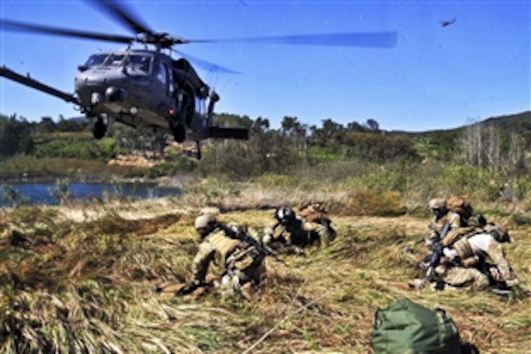A U.S. Air Force combat rescue officer and three pararescuemen prepare simulated casualties for transport before loading them onto an HH-60 Pave Hawk helicopter during a mass casualty training scenario as part of exercise Pacific Thunder 2012 near Osan Air Base, South Korea, Oct. 18, 2012. The officer and pararescuemen are assigned to the 31st Rescue Squadron.