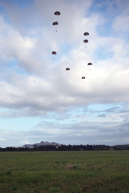 French Marine paratroopers descend after a jump during Exercise Croix du Sud at Camp la Broche on New Caledonia Oct. 13. The paratroopers jumped from 300 meters while British Army soldiers with The Royal Gurkha Rifles secured the landing zone during the initial phase of a multilateral, company-level attack.  