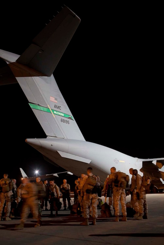 U.S. Marines with Headquarters Company, Regimental Combat Team 7 (RCT-7) disembark an.Air Force C-17 Globemaster III at Camp Bastion, Helmand Province, Afghanistan, Oct. 13, 2012. RCT-7 is embarking on a yearlong deployment to Afghanistan in support of Operation Enduring Freedom. (U.S. Marine Corps photo by Cpl. Alejandro Pena/Released)