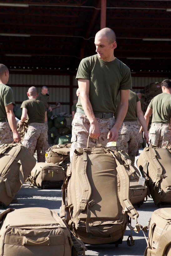 U.S. Marine Corps Lance Cpl. Kyle Coday, Headquarters Company, Regimental Combat Team 7 (RCT-7), loads gear onto palettes at Manas Air Base, Chuy province, Kyrgyzstan, Oct. 13, 2012. RCT-7 remained a few days on Manas Air Base before continuing on to their final destination in Afghanistan for a yearlong deployment. (U.S. Marine Corps photo by Cpl. Alejandro Pena/Released)