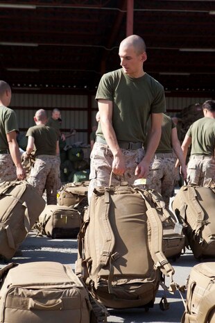 U.S. Marine Corps Lance Cpl. Kyle Coday, Headquarters Company, Regimental Combat Team 7 (RCT-7), loads gear onto palettes at Manas Air Base, Chuy province, Kyrgyzstan, Oct. 13, 2012. RCT-7 remained a few days on Manas Air Base before continuing on to their final destination in Afghanistan for a yearlong deployment. (U.S. Marine Corps photo by Cpl. Alejandro Pena/Released)