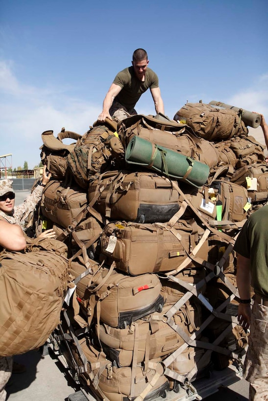 U.S. Marines with Headquarters Company, Regimental Combat Team 7 (RCT-7), load gear onto pallets prior to proceeding to Afghanistan at Manas Air Base, Chuy province, Kyrgyzstan, Oct. 13, 2012. RCT-7 staged a few days on Manas Air Base before continuing on to their final destination in Afghanistan for a yearlong deployment. (U.S. Marine Corps photo by Cpl. Alejandro Pena/Released)