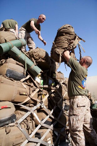U.S. Marines with Headquarters Company, Regimental Combat Team 7 (RCT-7), load gear onto pallets prior to proceeding to Afghanistan at Manas Air Base, Chuy province, Kyrgyzstan, Oct. 13, 2012. RCT-7 staged a few days on Manas Air Base before continuing on to their final destination in Afghanistan for a yearlong deployment. (U.S. Marine Corps photo by Cpl. Alejandro Pena/Released)