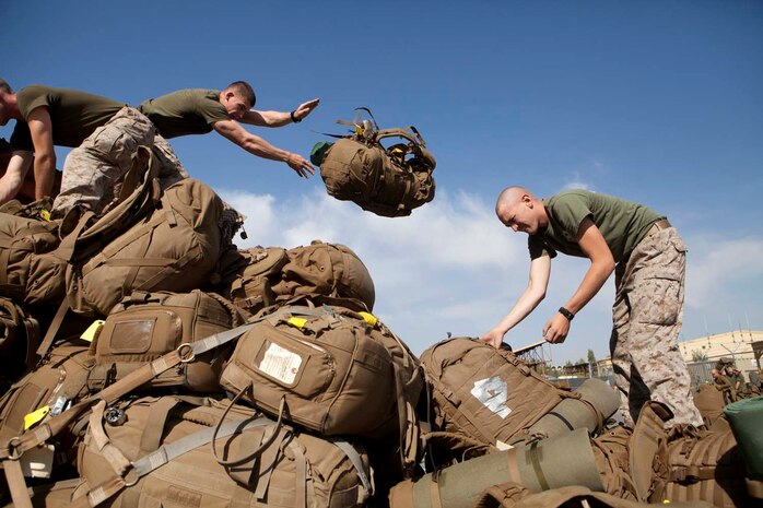 U.S. Marines with Headquarters Company, Regimental Combat Team 7 (RCT-7), load gear onto pallets prior to proceeding to Afghanistan at Manas Air Base, Chuy province, Kyrgyzstan, Oct. 13, 2012. RCT-7 staged a few days on Manas Air Base before continuing on to their final destination in Afghanistan for a yearlong deployment. (U.S. Marine Corps photo by Cpl. Alejandro Pena/Released)