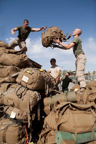 U.S. Marines with Headquarters Company, Regimental Combat Team 7 (RCT-7), load gear onto pallets prior to proceeding to Afghanistan at Manas Air Base, Chuy province, Kyrgyzstan, Oct. 13, 2012. RCT-7 staged a few days on Manas Air Base before continuing on to their final destination in Afghanistan for a yearlong deployment. (U.S. Marine Corps photo by Cpl. Alejandro Pena/Released)