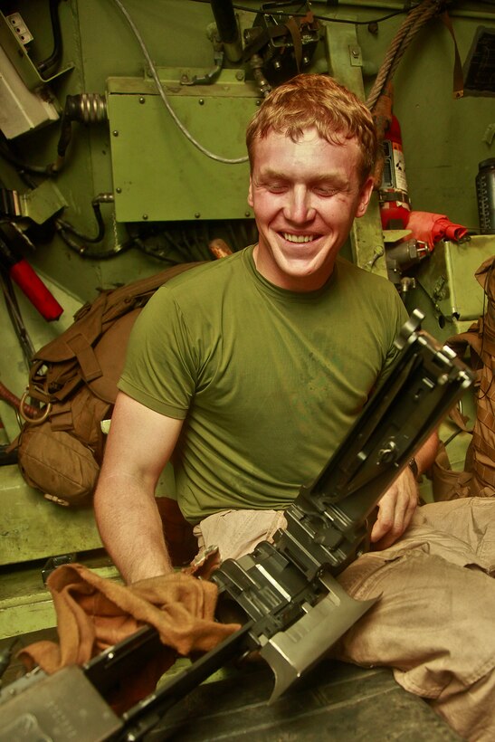Lance Cpl. Danny L. Daniels, an amphibious assault vehicle crewman with AAV Platoon, India Company, Battalion Landing Team 3/5, 15th Marine Expeditionary Unit, cleans off the .50 caliber heavy machine gun inside his crew’s AAV, in the well deck of the USS Green Bay, Oct. 17. In order to bring the Marines of India Co. to shore, the company’s AAV Platoon puts in countless hours toward achieving readiness with their AAVs. India Co. is one of three rifle companies that make up BLT 3/5, the 15th MEU’s ground combat element. The 15th MEU is currently embarked as part of the Peleliu Amphibious Ready Group, while they serve as the nation's rapid-response sea-based Marine Air Ground Task Force for Western Pacific Deployment 12-02. Daniels, 23, is from Walnut Bend, Texas.