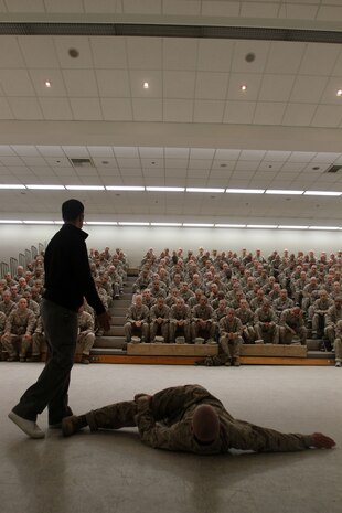 Recruits of Company D, 1st Recruit Training Battalion, recieve instruction on how to properly stretch and treat injuries such as shin splints aboard Marine Corps Recruit Depot San Diego Oct. 23. Afterwards recruits were taught combat care, which involved treating life threatening  injuries such as sunken chest wounds.