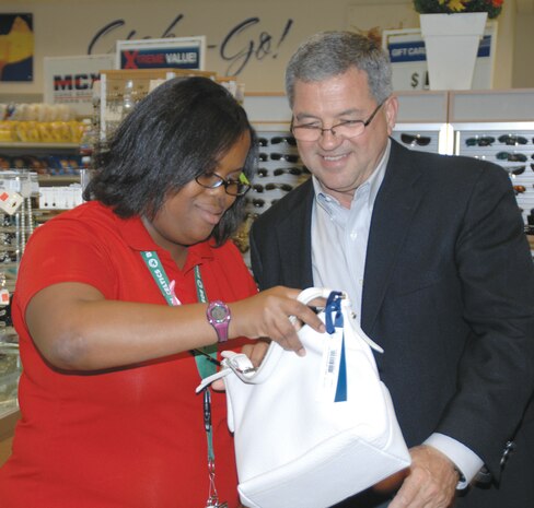 Dick French, former Marine Corps Community Services director, reviews inventory with Crystal Parker at the Marine Corps Exchange, Friday.