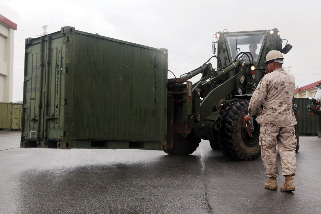 Lance Cpl. Steven Jimenez guides a forklift during a mobility exercise at Camp Foster Oct. 19. The exercise is conducted annually by Marine Wing Support Squadron 172 to increase proficiency and capabilities for future deployments. Jimenez is an embarkation specialist with MWSS-172, Marine Aircraft Group 36, 1st Marine Aircraft Wing, III Marine Expeditionary Force. 