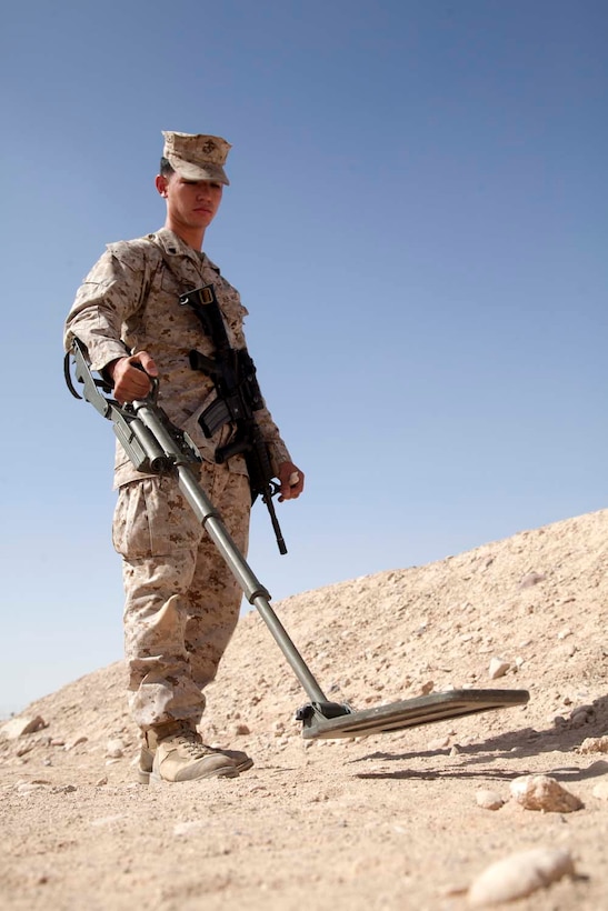 U.S. Marine Corps Cpl. Kowshon Ye, Headquarters Company, Regimental Combat Team 7, practices using a metal detector during the practical application portion of an improvised explosive device (IED) detection class at Camp Leatherneck, Helmand province, Afghanistan, Oct. 15, 2012. The class was part of counter IED training which familiarized the Marines with fundamentals to include: unexploded ordnance recognition, enemy tactics, homemade explosives, threat detection, ground signs awareness, and downed vehicle procedures. (U.S. Marine Corps photo by Cpl. Alejandro Pena/Released)