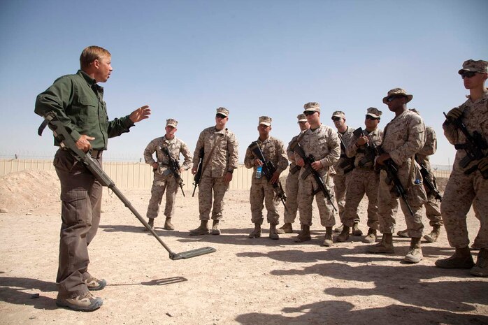 U.S. contracted instructor George Frick teaches the proper application of a metal detector to Marines with Headquarters Company, Regimental Combat Team 7, as part of counter improvised explosive device (IED) training at Camp Leatherneck, Helmand province, Afghanistan, Oct. 15, 2012. The counter IED training familiarized the Marines with fundamentals to include: unexploded ordnance recognition, enemy tactics, homemade explosives, threat detection, ground signs awareness, and downed vehicle procedures. (U.S. Marine Corps photo by Cpl. Alejandro Pena/Released)