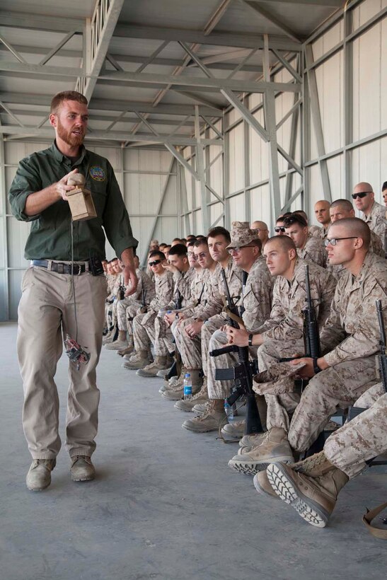 U.S. contracted instructor Jesse Pickerill displays an example detonation device to Marines with Headquarters Company, Regimental Combat Team 7 as part of counter improvised explosive device (IED) training at Camp Leatherneck, Helmand province, Afghanistan, Oct. 15, 2012. The counter IED training familiarized the Marines with fundamentals to include: unexploded ordnance recognition, enemy tactics, homemade explosives, threat detection, ground signs awareness, and downed vehicle procedures. (U.S. Marine Corps photo by Cpl. Alejandro Pena/Released)