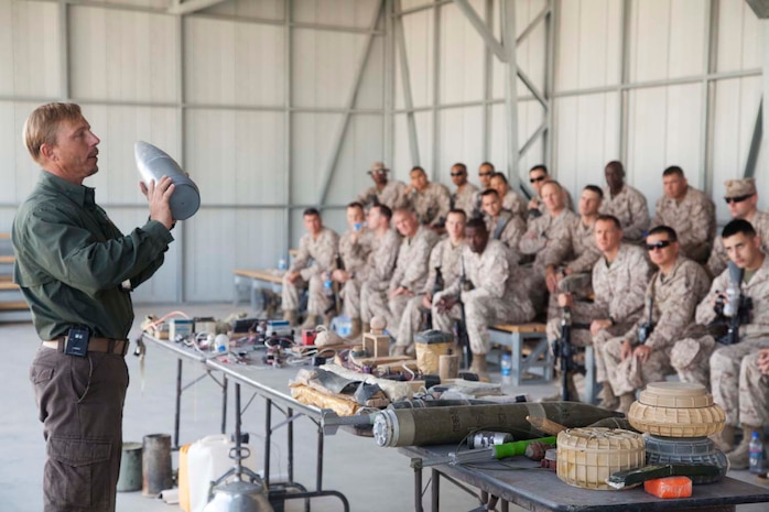 U.S. contracted instructor George Frick displays inactive ordnance to U.S. Marines with Headquarters Company, Regimental Combat Team 7 as part of counter improvised explosive device (IED) training at Camp Leatherneck, Helmand province, Afghanistan, Oct. 15, 2012. The counter IED training familiarized the Marines with fundamentals to include: unexploded ordnance recognition, enemy tactics, homemade explosives, threat detection, ground signs awareness, and downed vehicle procedures. (U.S. Marine Corps photo by Cpl. Alejandro Pena/Released)