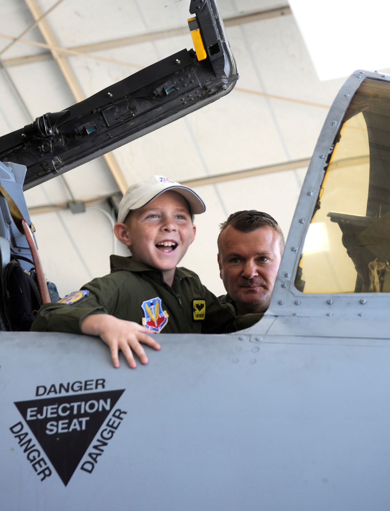 Eight-year-old Larry Ronstadt smiles as host pilot U.S. Air Force Maj. Richard Benda, 357th Fighter Squadron, explains the cockpit of the A-10 Thunderbolt II on Oct 25, 2012, during the Pilot for a Day event of Davis-Monthan Air Force Base, Ariz.  Larry was a Pilot for a Day for the 357th Fighter Squadron, and Major Benda is the Assistant Director of Operations for the 357 FS.   Pilot for a Day is a program which provides children with a terminal illness a day to visit the base and become an honorary pilot for one of the operational squadrons.  (U.S. Air Force photo by 1LT Susan Harrington/released)