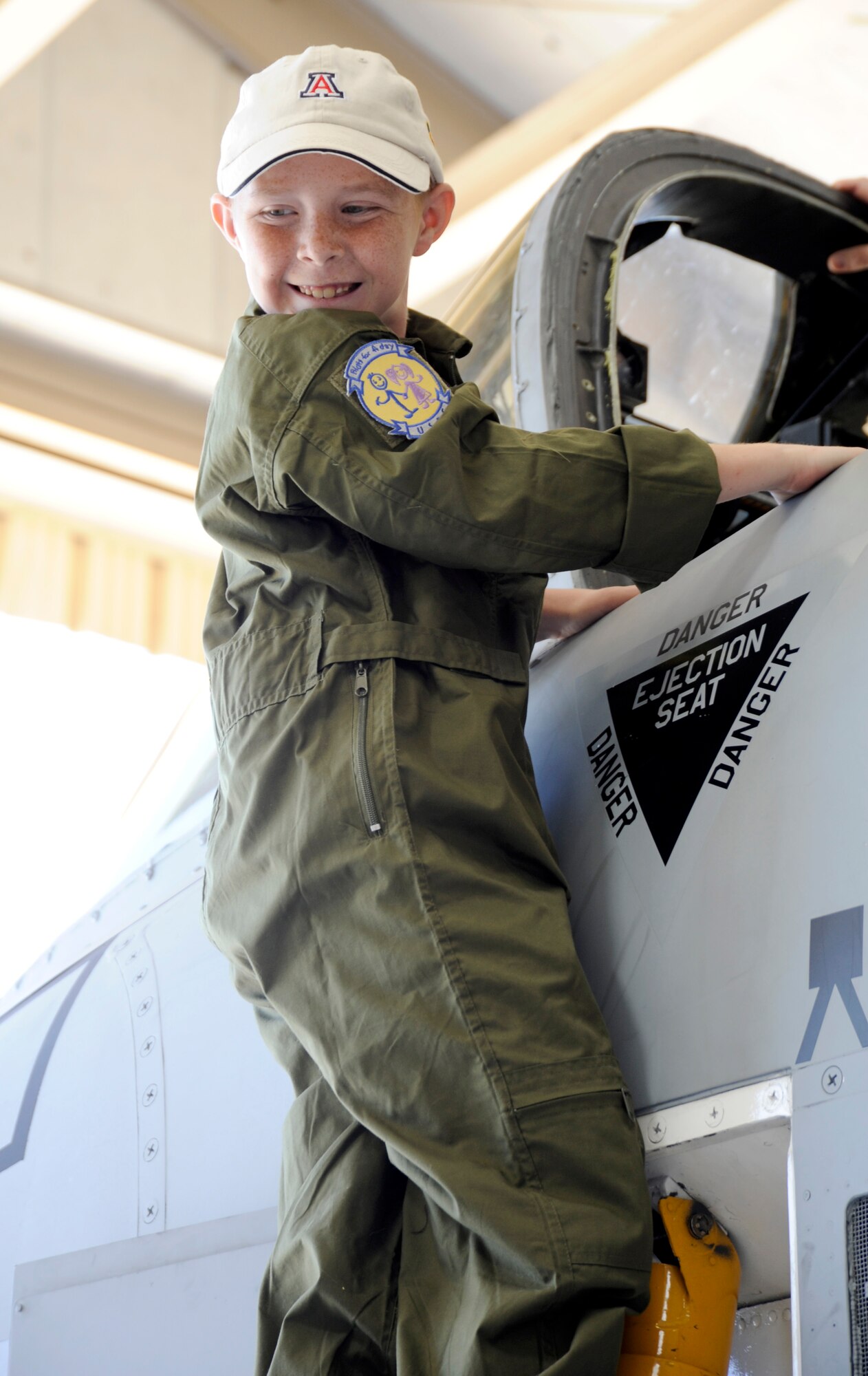 Eight-year-old Larry Ronstadt climbs into the cockpit of an A-10 Thunderbolt II static on Oct 25, 2012, during the Pilot for a Day event at Davis-Monthan Air Force Base, Ariz.  Pilot for a Day is a program which provides children with a terminal illness a day to visit the base and become an honorary pilot for one of the operational squadrons.  (U.S. Air Force photo by 1LT Susan Harrington/released)