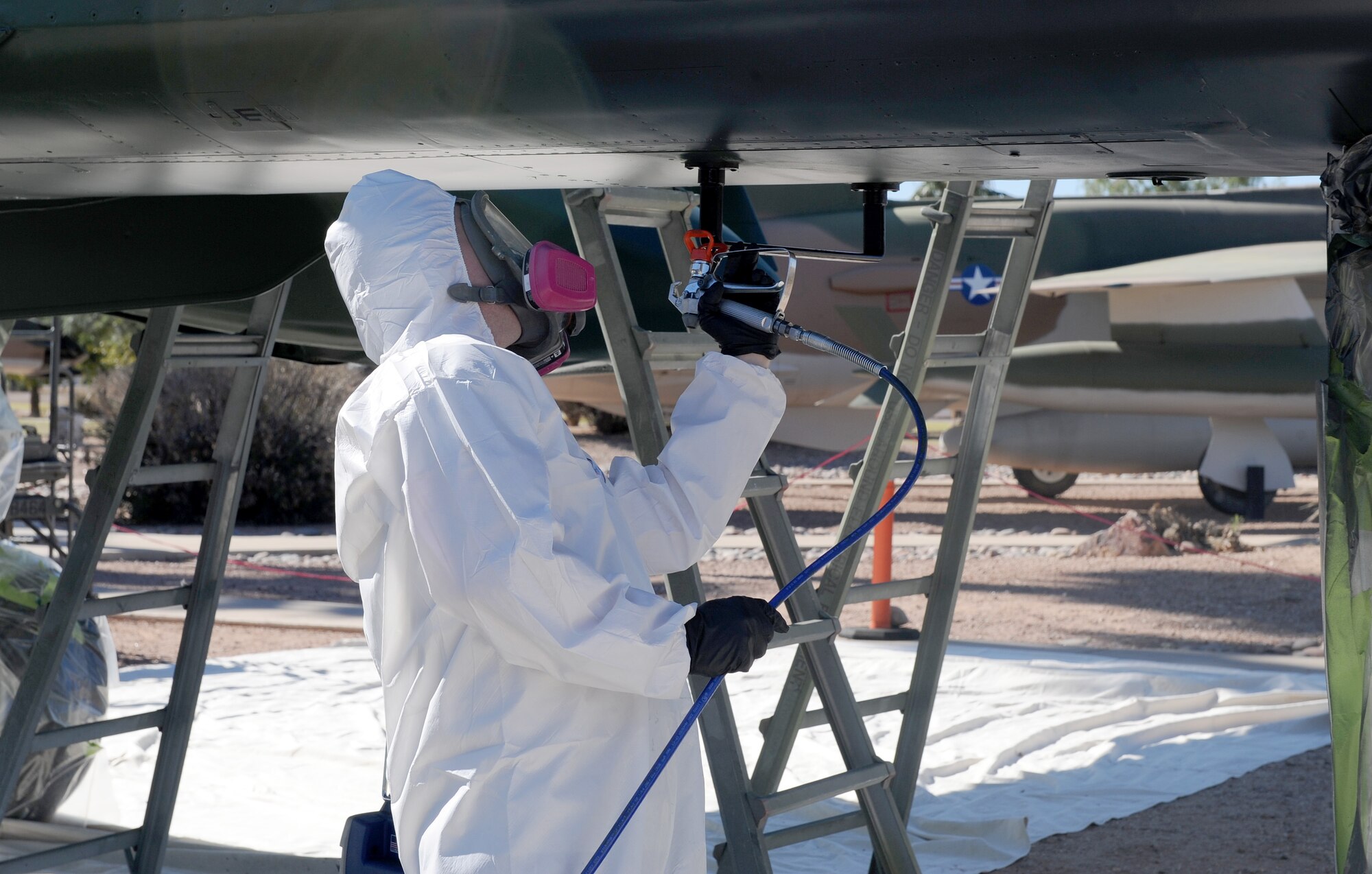 U.S. Air Force Senior Airman Clint Black and Airman 1st Class Jesse Thompson, 355th Aircraft Maintenance Squadron aircraft structural maintenance journeymen, apply a sticker to the side of an A-10 Thunderbolt II during the refurbishment of Heritage Park on Davis-Monthan Air Force Base, Ariz., Oct. 24, 2012. Aircraft at Heritage Park are refurbished every three to four years to prevent corrosion. (U.S. Air Force photo by Senior Airman Brittany Dowdle/released)