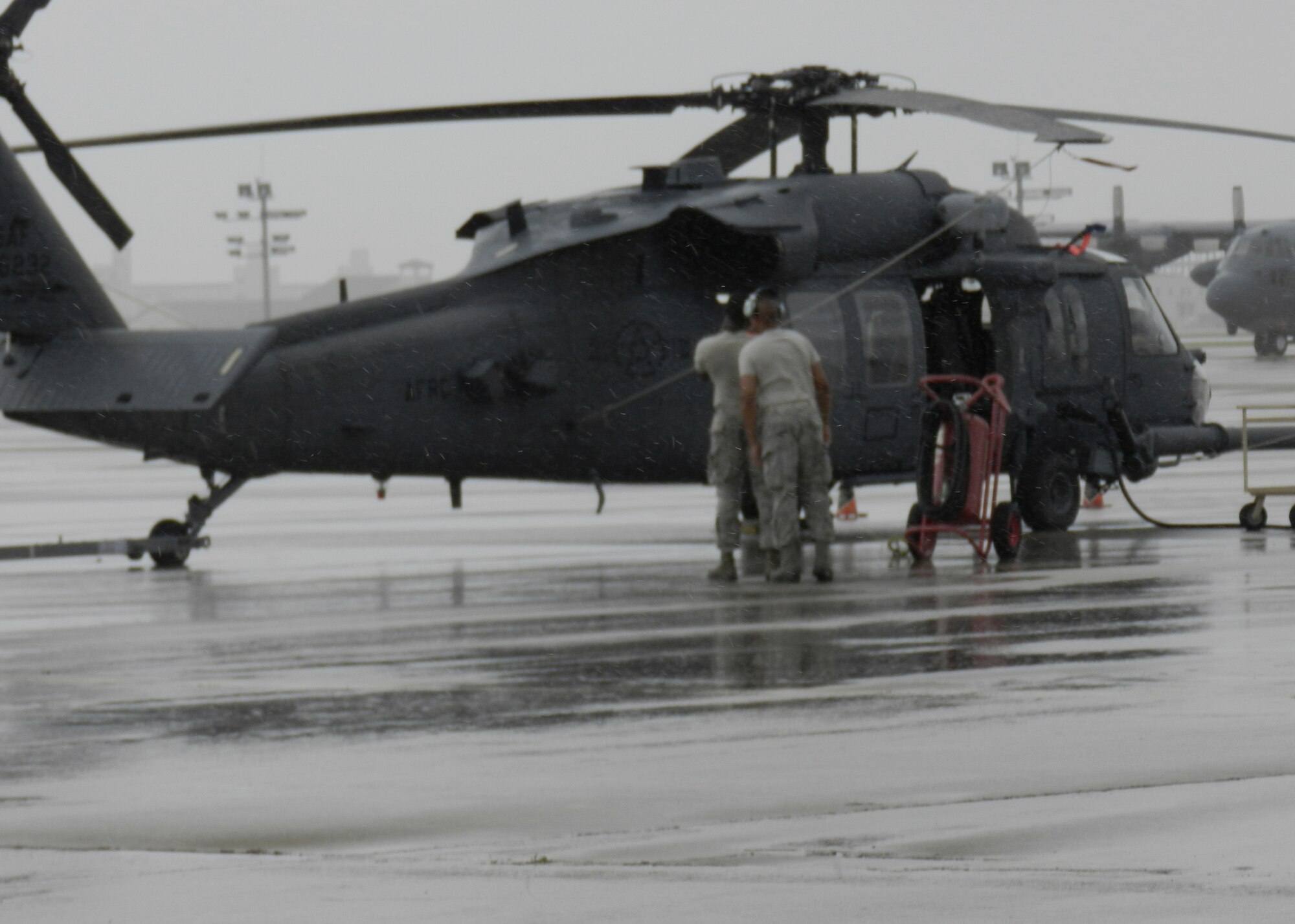 As a category 1 hurricane headed for Patrick Air Force Base Oct. 26, maintenance Airmen drug one Pave Hawk out onto the open ramp to perform avionic systems operations checks. In between rain bands they huddled inside the aircraft during some of the more gusty conditions to finish their work for the day before tucking the helicopter back into the hangar with the rest of the aircraft for safekeeping. (U.S. Air Force photo/Capt. Cathleen Snow)                      