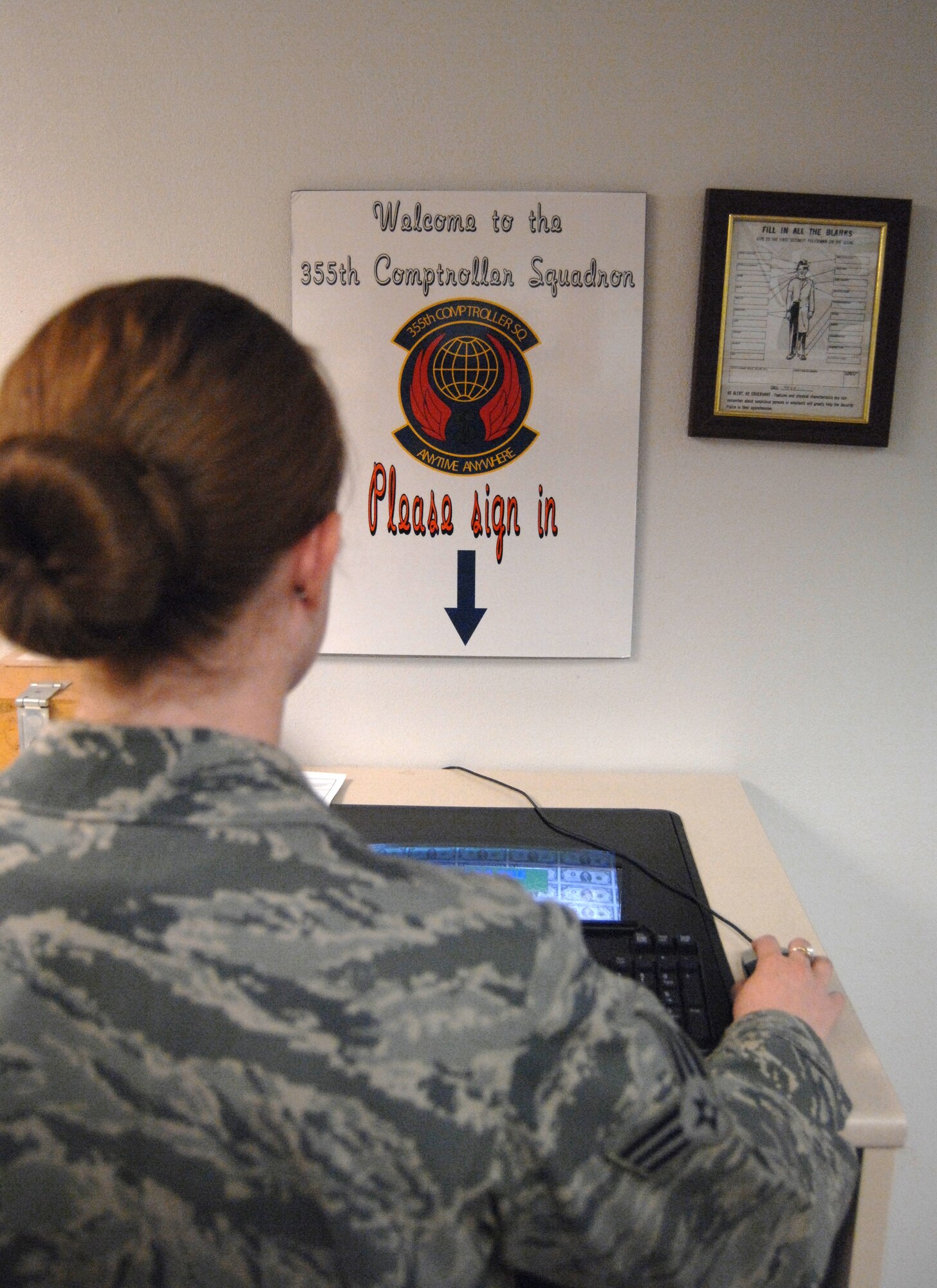 An Airman signs in to be seen at the customer service section of the 355th Comptroller Squadron on Davis-Monthan Air Force Base, Ariz. Oct. 25. The average wait time at the customer service area is roughly seven minutes. (U.S. Air Force photo by Senior Airman Michael Washburn/Released)