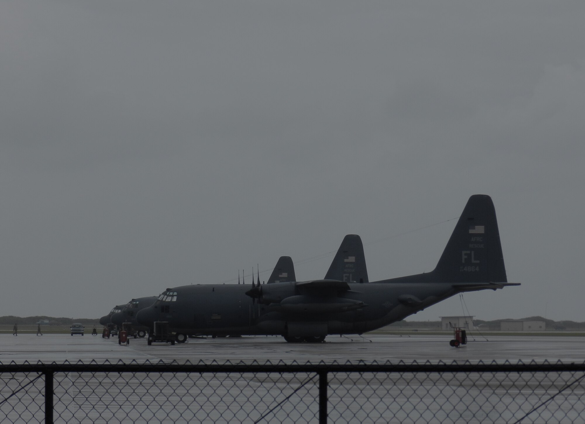 Although no flying was scheduled within the 920th Rescue Wing, Patrick Air Force Base, Fla., today, maintenance Airmen took precautions against Hurricane Sandy as the category 1 crept up the coast toward Patrick by policing light loose items in and around the flightline, in addition to mooring down the 920ths HC-130P/N King fixed-wing aircraft by fastening chains to the tail, nose and wings to steel rings embedded into the ramp. They also tucked all six of the wing's helicopters in an aircraft hangar. (U.S. Air Force photo/Capt. Cathleen Snow)