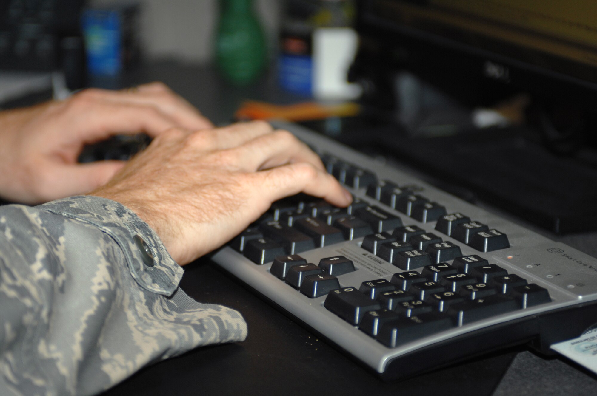 U.S. Air Force Staff Sgt. Andrew Kruczyk, 355th Comptroller Squadron customer service team lead, types on his keyboard at Davis-Monthan Air Force Base, Ariz. Oct. 25. (U.S. Air Force photo by Senior Airman Michael Washburn/Released)