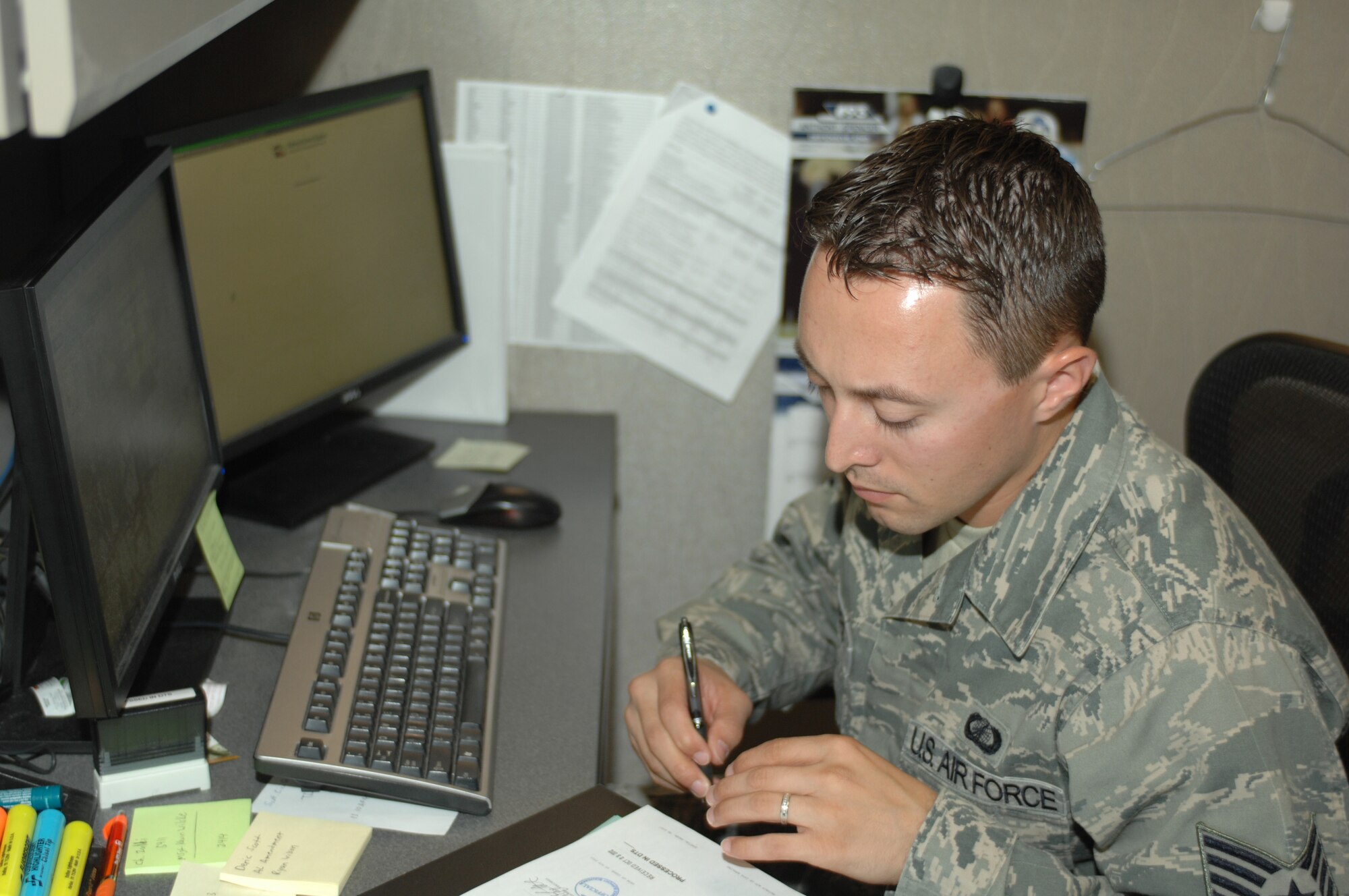 U.S. Air Force Staff Sgt. Micha Vickers, 355th Comptroller Squadron lead defense travel administrator, fills out paperwork at Davis-Monthan Air Force Base, Ariz. Oct. 25. (U.S. Air Force photo by Senior Airman Michael Washburn/Released)