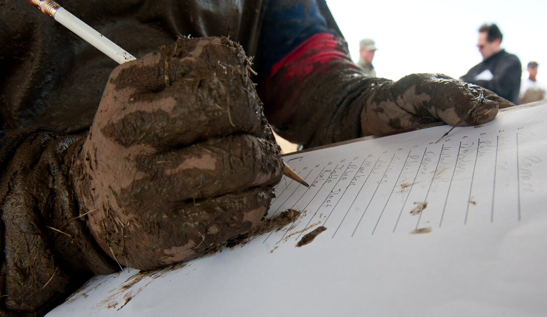 Dustin Born, 28th Civil Engineer Squadron deputy chief of operations, completes a mental obstacle during the 2012 Mud Run at Ellsworth Air Force Base, S.D., Oct. 23, 2012. The obstacle challenged participants to memorize household items at the beginning of the race and list them at the finish line. Participants had an additional 30 seconds added to their overall time for every incorrect answer. (U.S. Air Force photo by Airman 1st Class Kate Thornton-Maurer/Released)