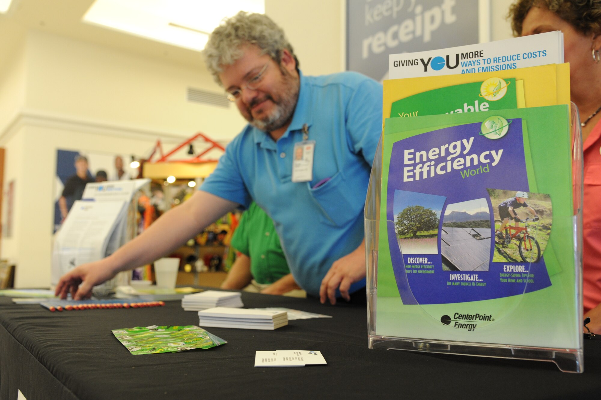 Michael Barker, Keesler Resource Efficiency Manager, sets out pamphlets and mementos at the Exchange to promote Energy Action Month Oct. 24, 2012, Keesler Air Force Base, Miss. Energy Action Month provides an opportunity to promote energy and water conservation awareness to Airmen as part of a national campaign led by the Department of Energy.  (U.S. Air Force photo by Kemberly Groue)