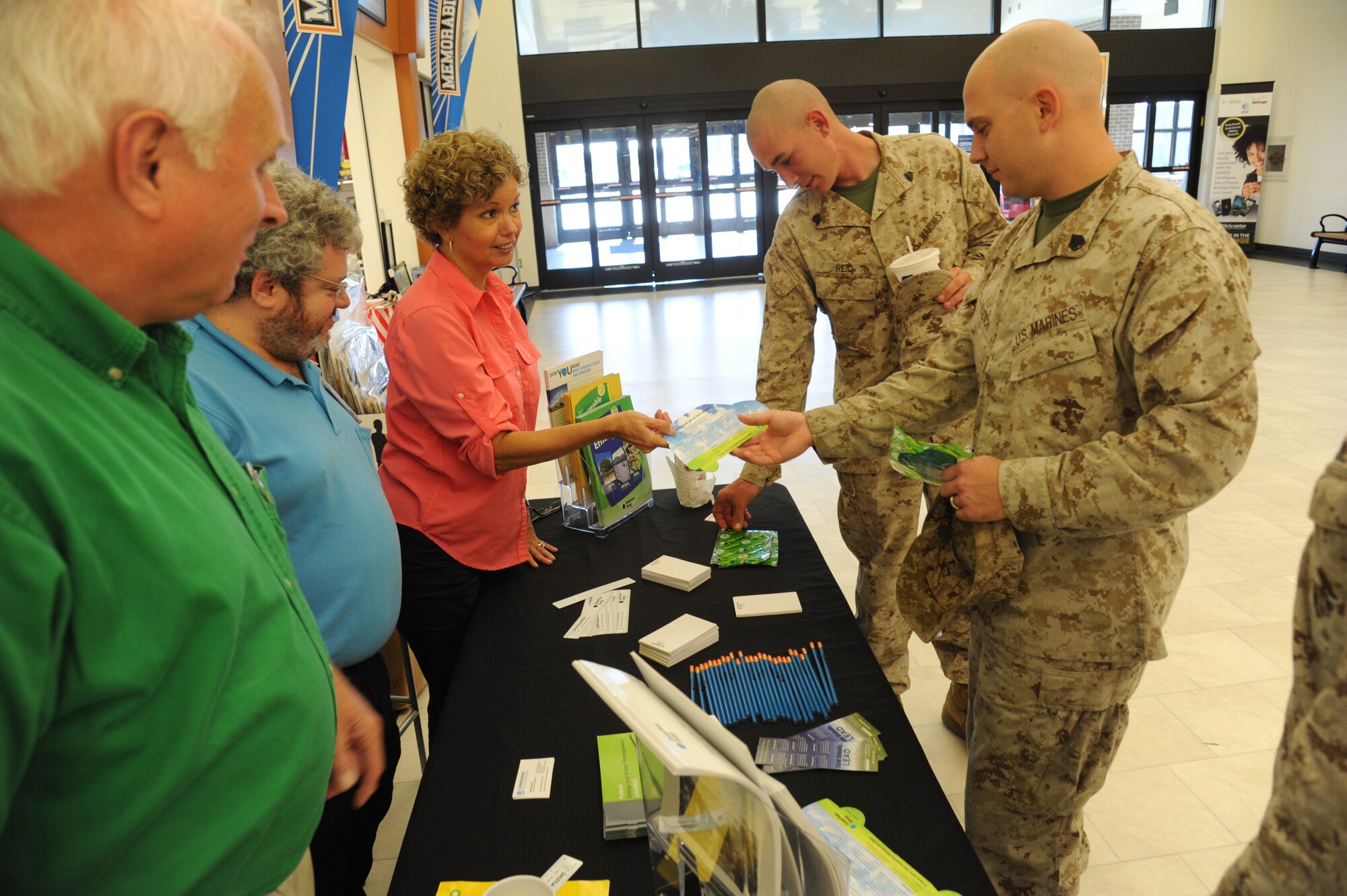 Charles Campbell, Center Point Energy; Michael Barker, Keesler Resource Efficiency Manager; and Darlene Stewart, Center Point Energy, provide pamphlets and mementos to Marine Sgt. Jon Reid and Marine Staff Sgt. Chad Radich, Keesler Marine Detachment, at the Exchange to promote Energy Action Month Oct. 24, 2012, Keesler Air Force Base, Miss. Energy Action Month provides an opportunity to promote energy and water conservation awareness to Airmen as part of a national campaign led by the Department of Energy.  (U.S. Air Force photo by Kemberly Groue)
