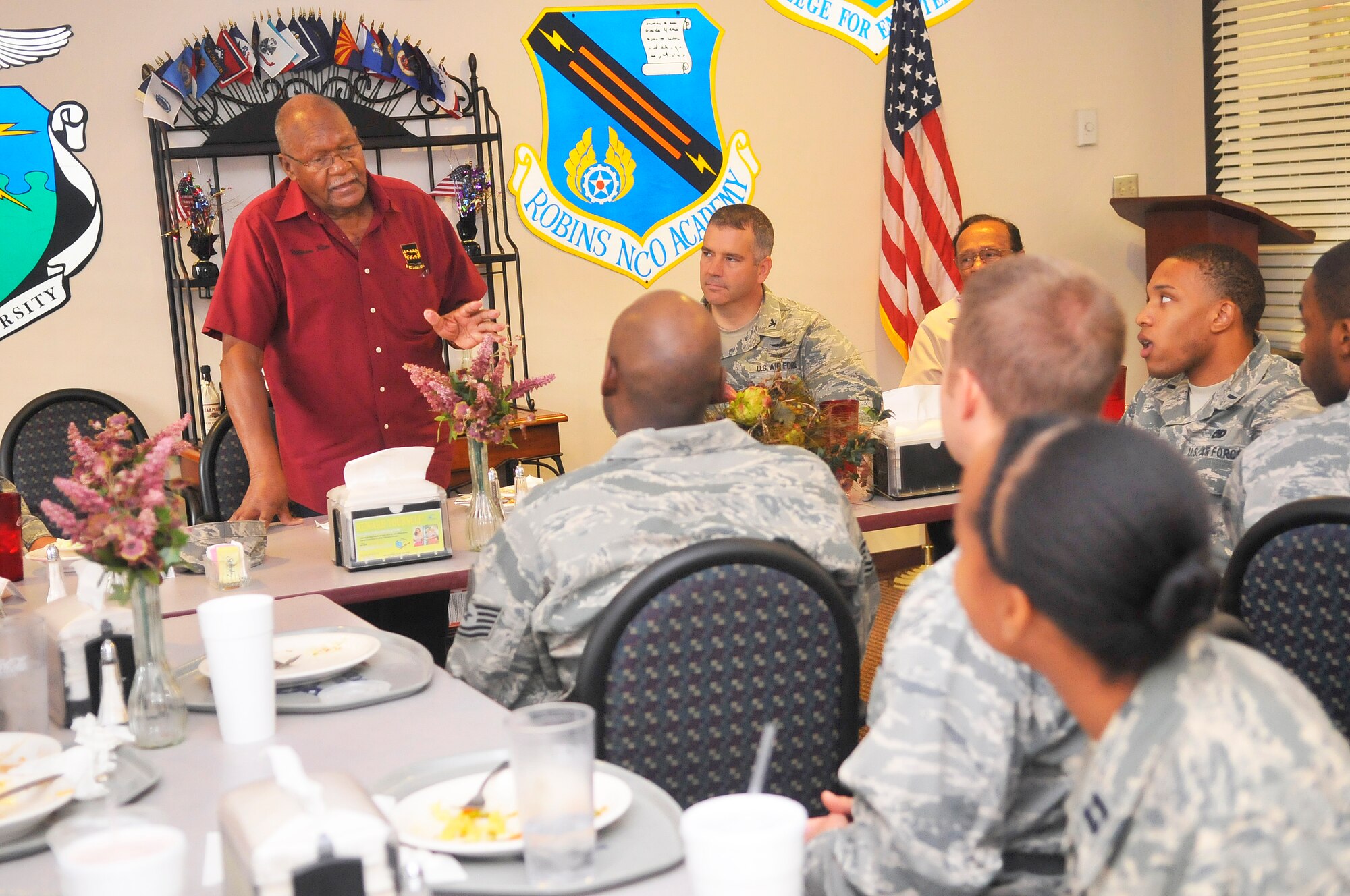 Tuskegee Airman William Rice stops at the Wynn Dining Facility to have lunch with a group of Robins Airmen during his tour here Friday. Rice was a fighter pilot with the 332nd Fighter Group during WWII. The Tuskegee Airmen were the first African- American aviators in the United States Armed Forces. (U. S. Air Force photo/Sue Sapp)