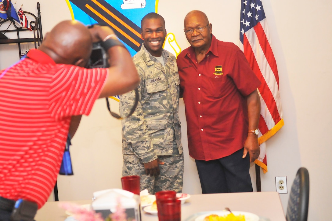 First Lt. Femi Obadina, 78th ABW/JA, poses for a photo with Tuskegee Airman William Rice. Rice was a fighter pilot with the 332nd Fighter Group during WWII. The Tuskegee Airmen were the first African- American aviators in the United States Armed Forces. (U. S. Air Force photo/Sue Sapp)