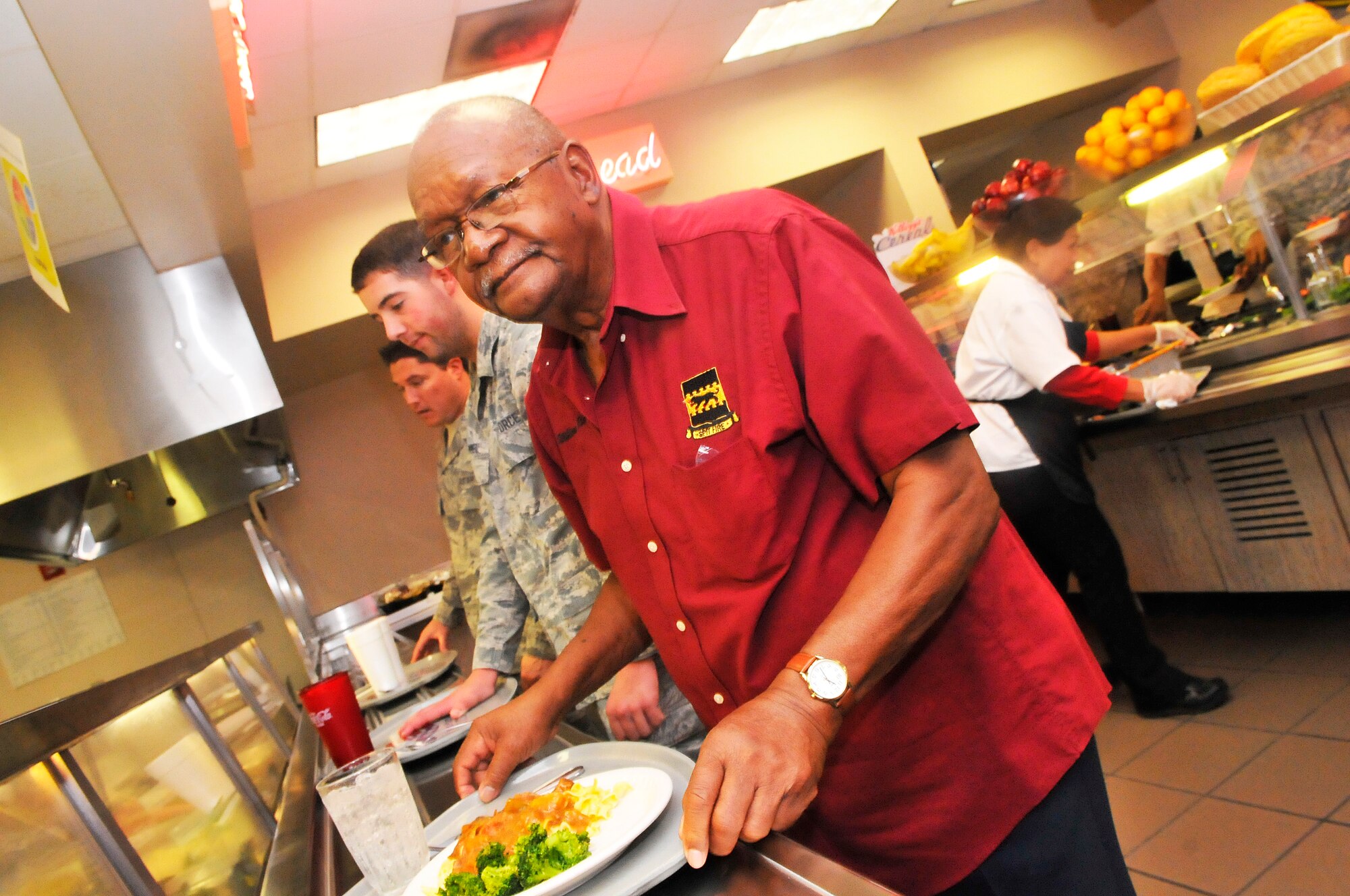 Tuskegee Airman William Rice stops at the Wynn Dining Facility to have lunch with a group of Robins Airmen during his tour here Friday. Rice was a fighter pilot with the 332nd Fighter Group during WWII. The Tuskegee Airmen were the first African- American aviators in the United States Armed Forces. (U. S. Air Force photo/Sue Sapp)