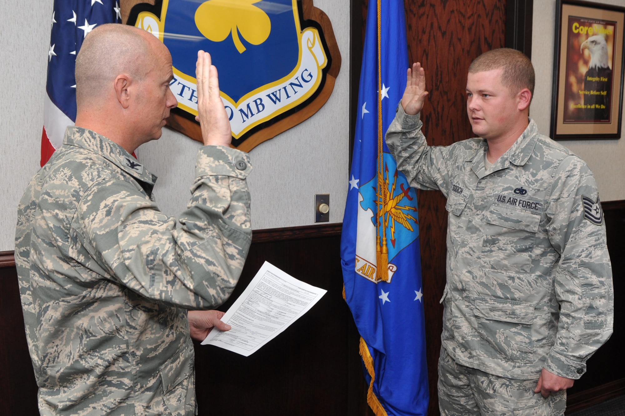 Col. Jonathan Ellis, commander of the 307th Bomb Wing, re-enlists Tech. Sgt. Thomas Gooch, at Barksdale Air Force Base, La., Oct. 24, 2012. As a part of Total Force Enterprise, Gooch, who is assigned the 2nd Aircraft Maintenance Squadron, works side-by-side with Reserve Airmen, and is the dedicated crew chief for the 307 BW Commander’s B-52 Stratofortress. Gooch has been in the Air Force for 14 years. This re-enlistment will take him all the to the 20-year mark of his military career. (U.S. Air Force photo by Master Sgt. Jeff Walston)