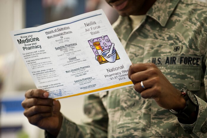 Airman 1st Class Perez Oppong, 99th Medical Support Squadron pharmacy technician apprentice, reads a brochure about National Pharmacy Week Oct 23, 2012, at Nellis Air Force Base, Nev.  Pharmacists and pharmacy technicians are at the Base Exchange answering questions and giving consultations to anyone with questions about their medication. (U.S. Air Force photo by Airman 1st Class Jason Couillard)
