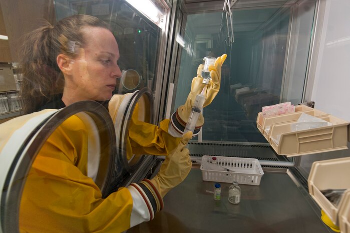 Sara Ermer, 99th Medical Support Squadron pharmacy technician, makes a medication drip using a microsphere Oct. 23, 2012, at Nellis Air Force Base, Nev.  The microsphere reduces outside contaminants and keeps products sterile. (U.S. Air Force photo by Airman 1st Class Jason Couillard)