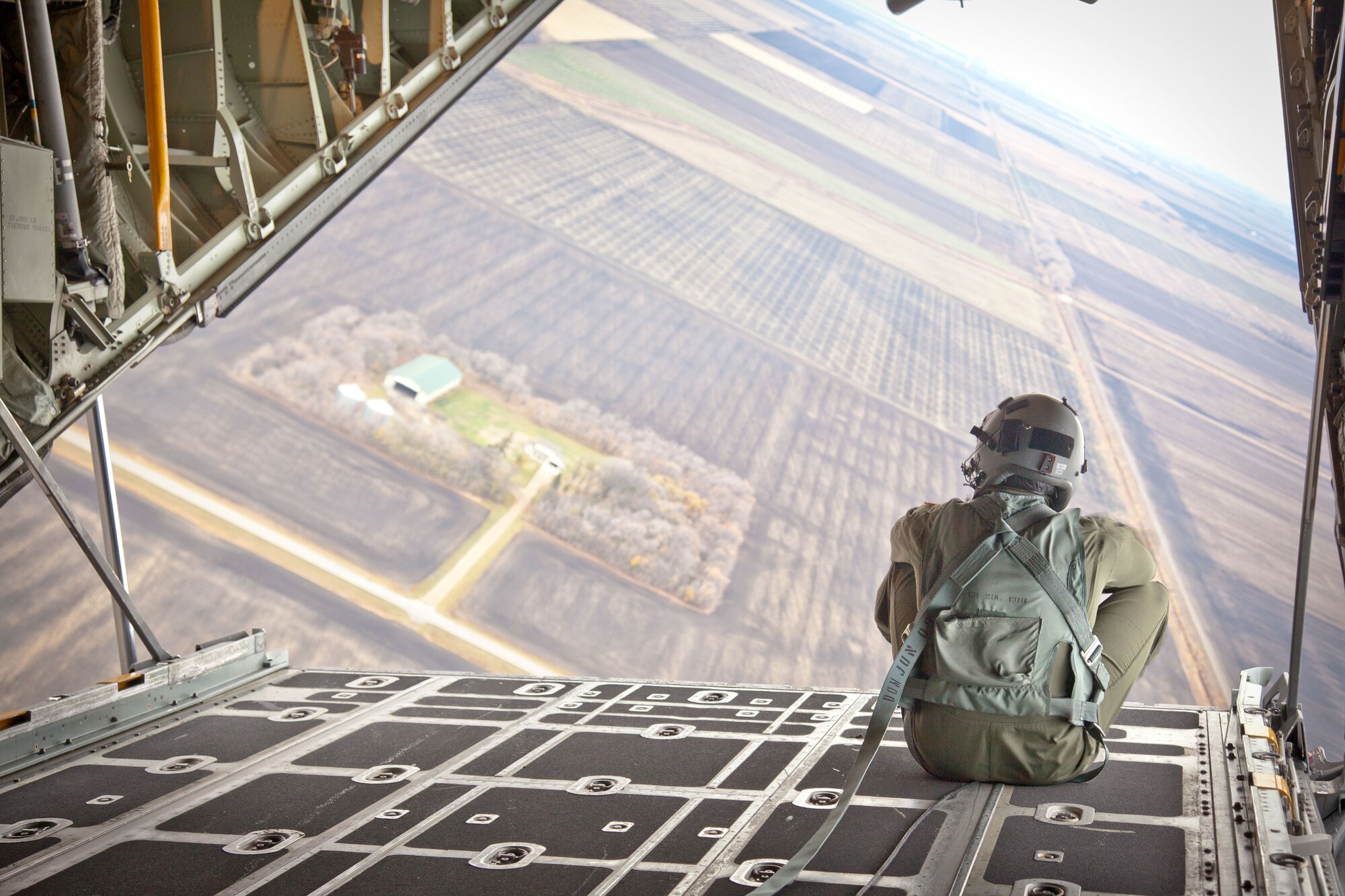 Loadmaster Senior Airman Dylan Strom enjoys the view during the flight.  Clergy and civic leaders from the local area participated in an orientation flight with the 934th Airlift Wing October 25.  (U.S. Air Force Photo/Shannon McKay)