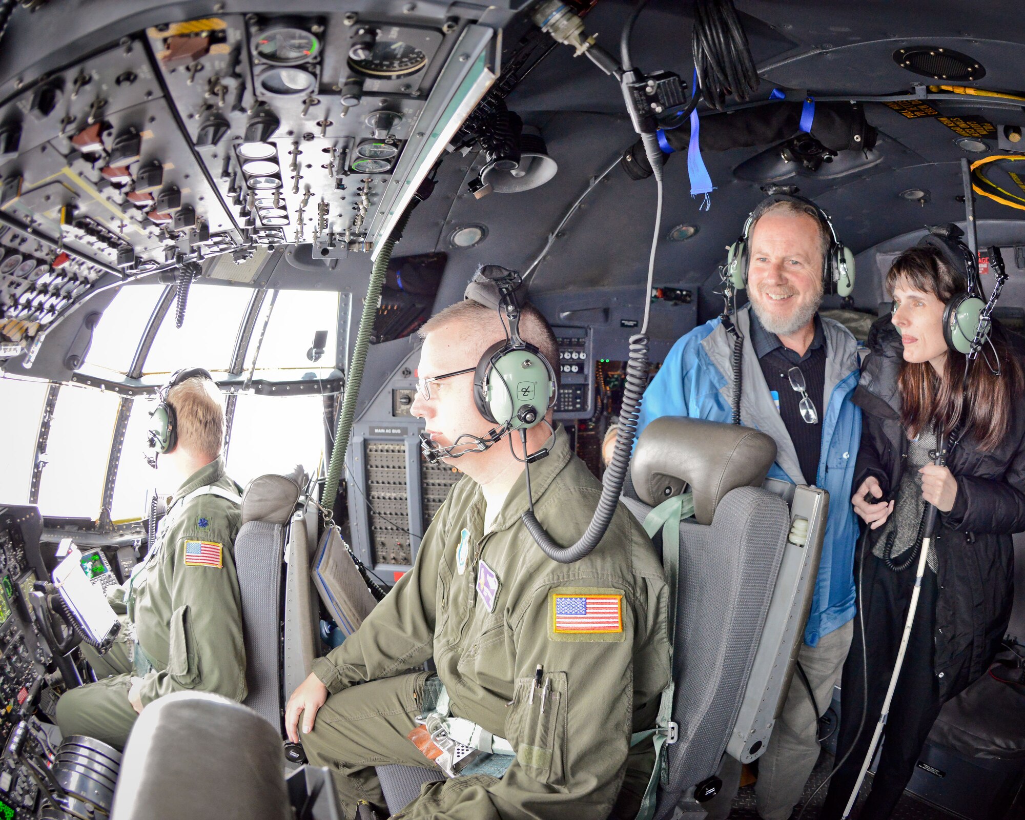 Ann Marie Wagner and Eric Ringham learn about the flight deck from Lt. Col. Robert Hockman and Master Sgt. Danny Richardson. Civic leaders and clergy members from the local area participated in an orientation flight with the 934th Airlift Wing October 25.  (U.S. Air Force Photo/Shannon McKay)