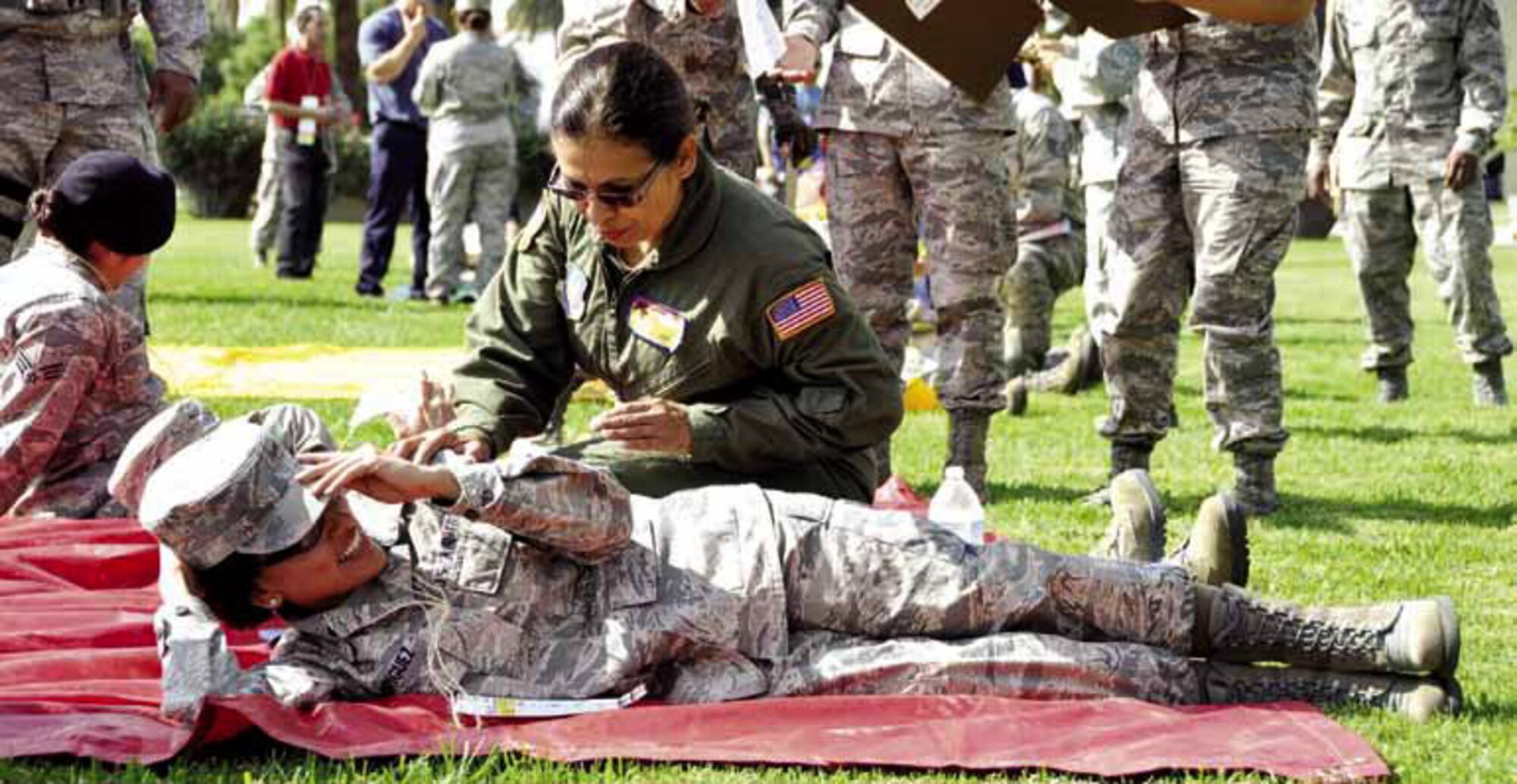 Senior Master Sgt. Jo Carrillo, 452nd Aeromedical Evacuation Squadron, evaluates Senior Airman Iesha Rodriguez, 752nd Medical Squadron, for simulated injuries, during The Great Shake Out earthquake exercise. (U.S. Air Force photo by Linda Welz)