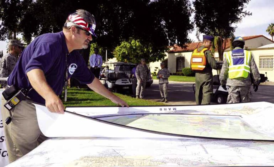 Marv Tucker, director, 452nd Air Mobility Wing Emergency Management, reviews a base map during The Great Shake Out earthquake exercise. (U.S. Air Force photo by Linda Welz)