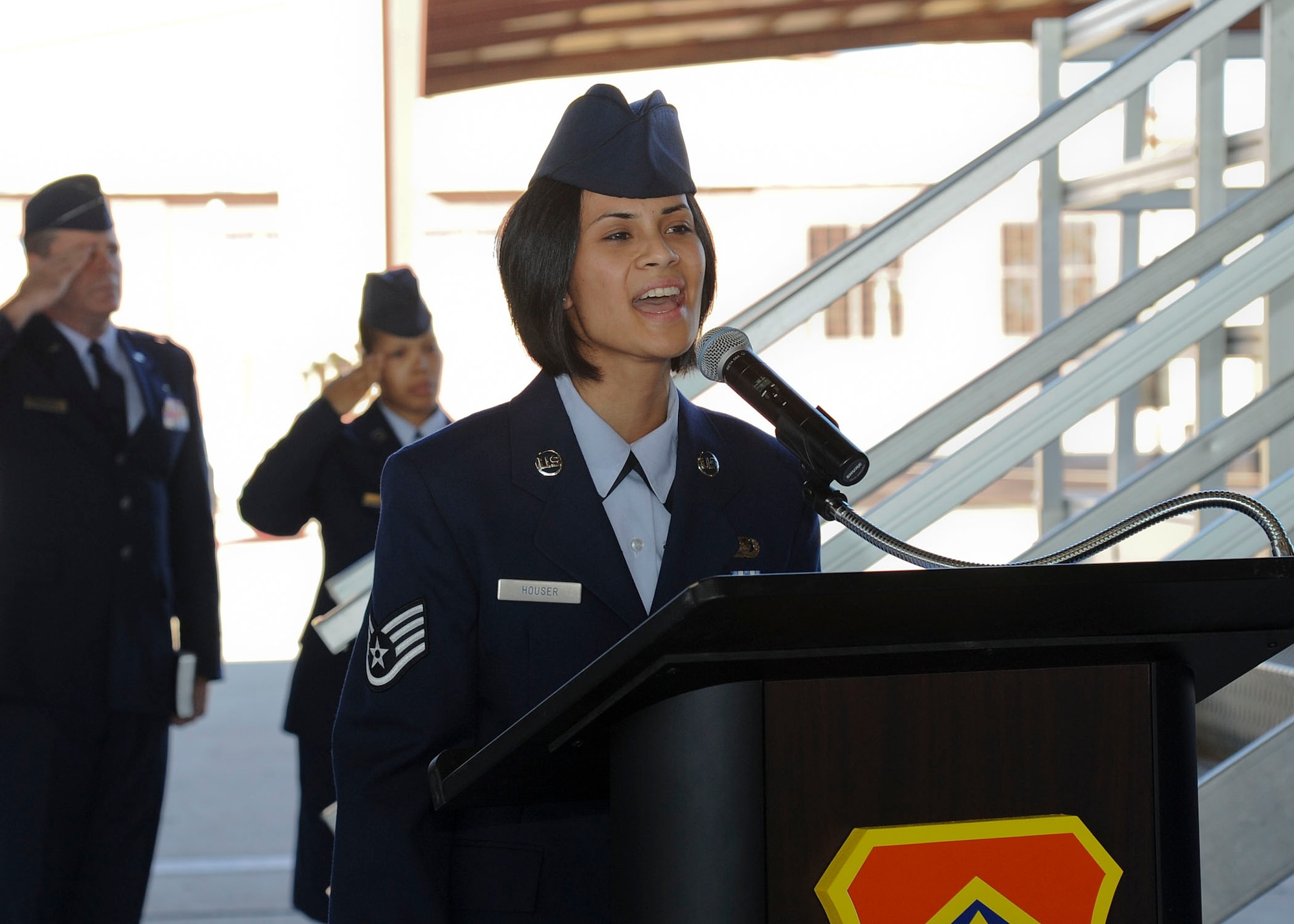 Staff Sgt. Sasha Houser, 56th Force Support Squadron installation personnel readiness assistant NCO-in-charge, performs the national anthem Sept. 12 at the 56th Fighter Wing change-of-command ceremony. Houser has sung at many events, but her favorite to perform at is retirements.  (U.S. Air Force photo by Staff Sgt. Darlene Seltmann)